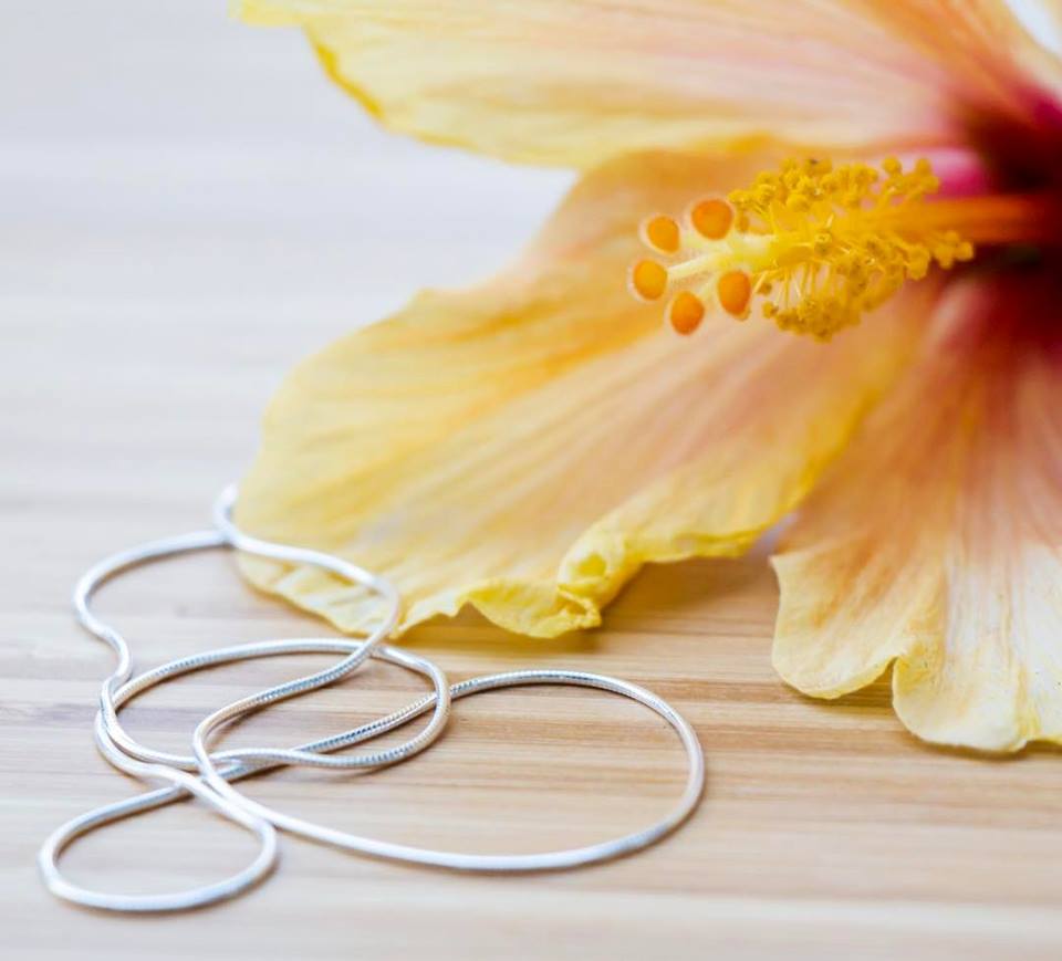 1MM Sterling Silver Snake Chain with Lobster Claw Clasp. Italian Sterling Silver, 16"-30". Displayed next to a beautiful yellow flower.