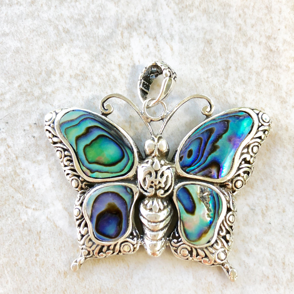 Abalone and Sterling Silver Butterfly Pendant. About an inch and a quarter. Lovely abalone.. Lovely silver scroll work. Made in Bali.