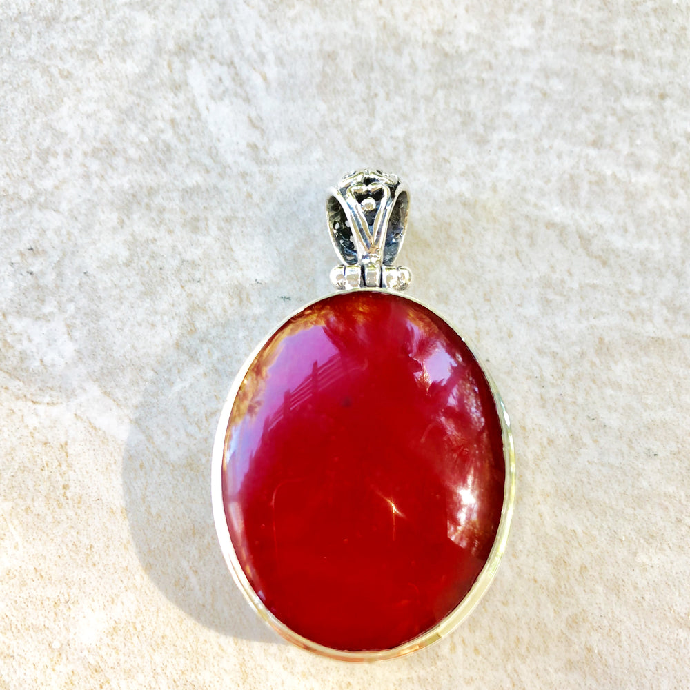 Abalone or Red Coral double sided Sterling Silver Pendant. Abalone on one side, red coral on the other. Oval shape. one and a half inches long