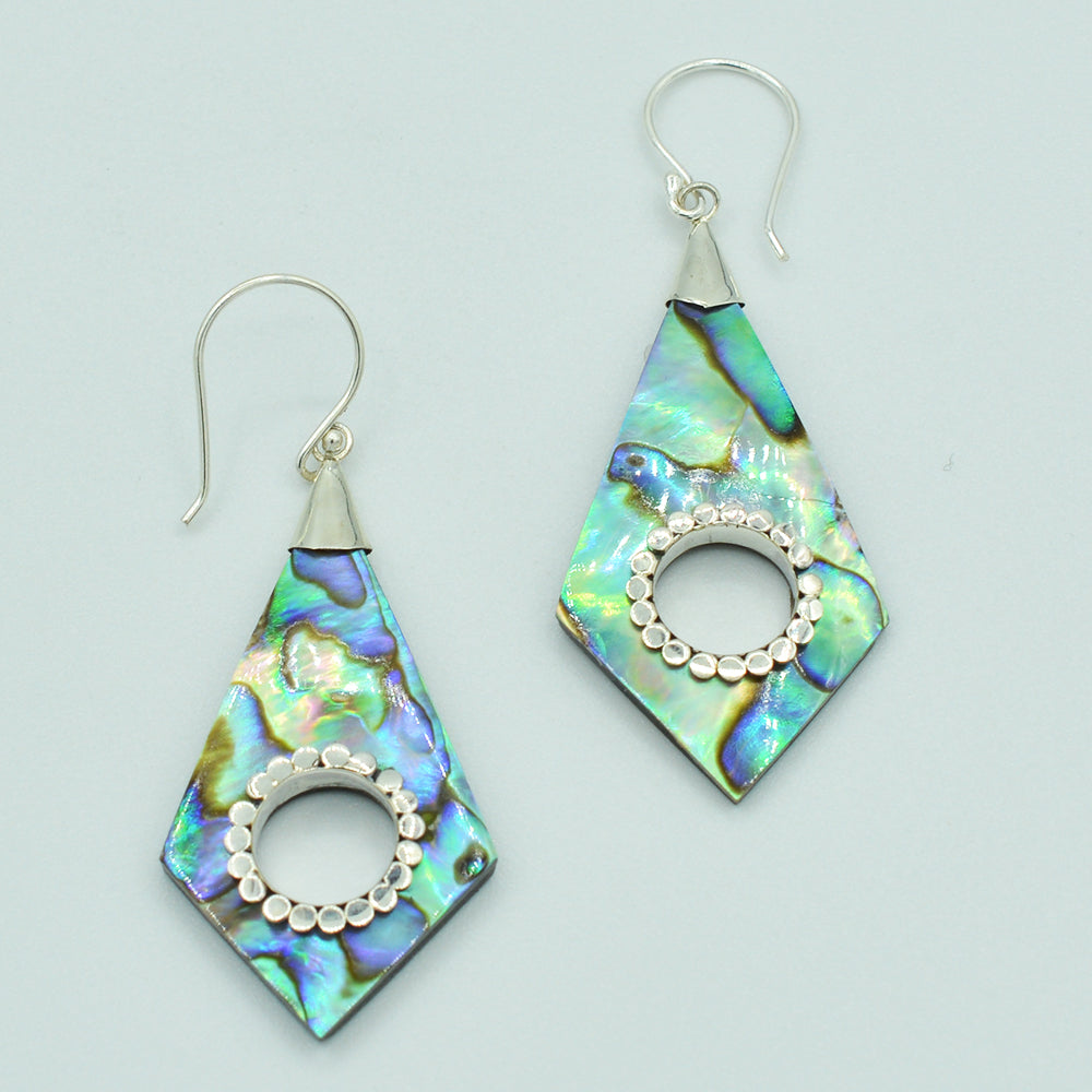 Abalone or Mother of Pearl Sterling Silver Earrings. Geometric diamond shape. Silver work. one and a quarter inch long. Pierced earrings. Fish hook There is a whole cut out in the center with silver scalloped around the edge of the whole.