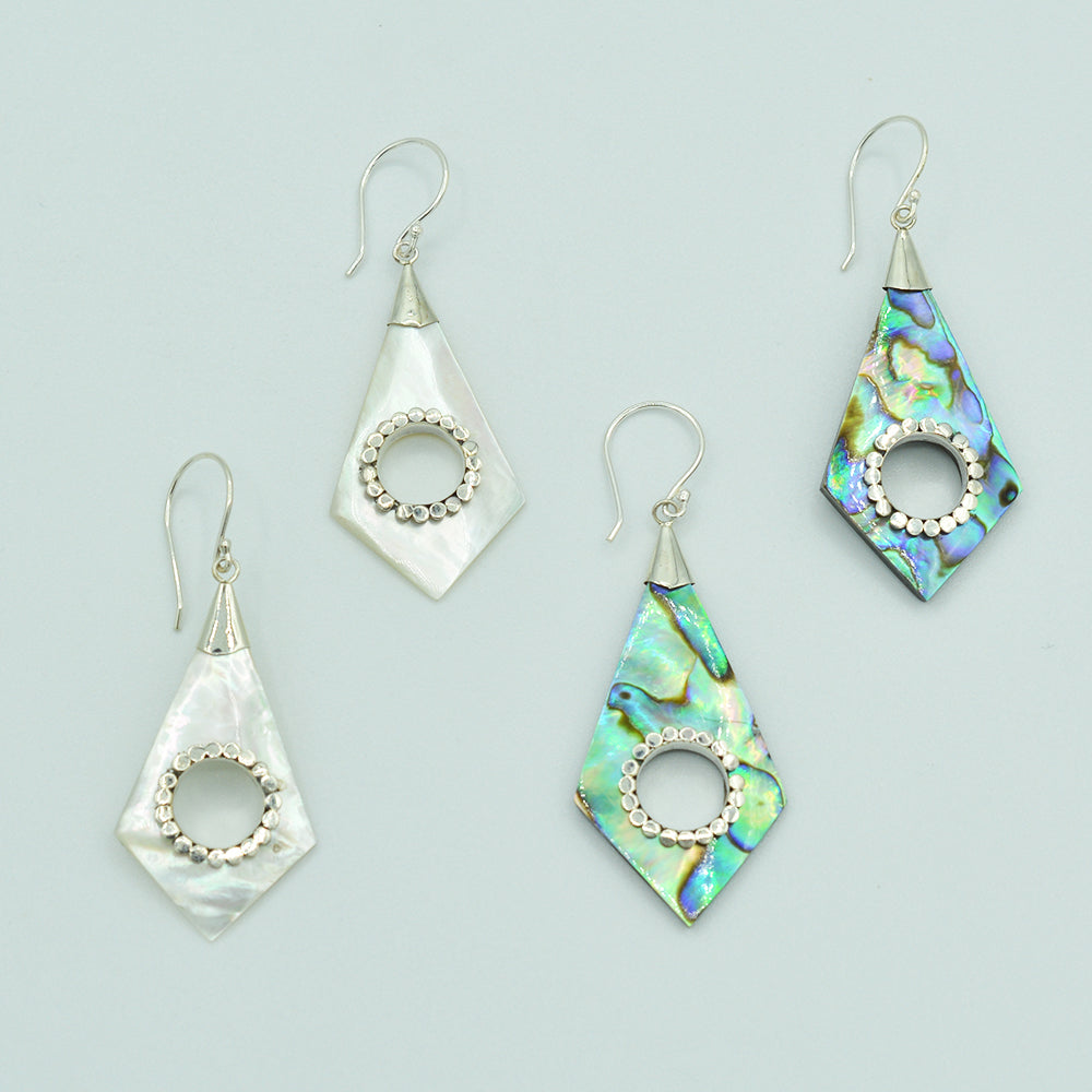 Abalone or Mother of Pearl Sterling Silver Earrings. Geometric diamond shape. Silver work. one and a quarter inch long. Pierced earrings. Fish hook There is a whole cut out in the center with silver scalloped around the edge of the whole.