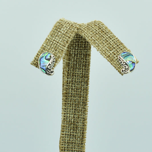 Abalone and Sterling Silver Stud Earrings. Pierced stud earrings with abalone and sterling silver scroll work. Less than a half inch in size.