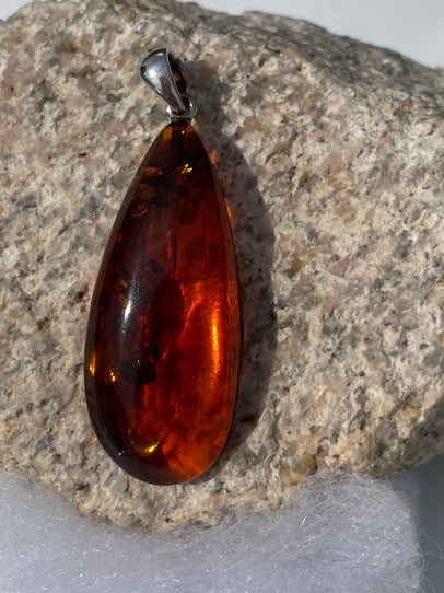 Amber pendant. Cognac sterling silver, elongated tear drop Amber pendant. This pendant makes its own statement as it seems amber always does. A lovely piece.