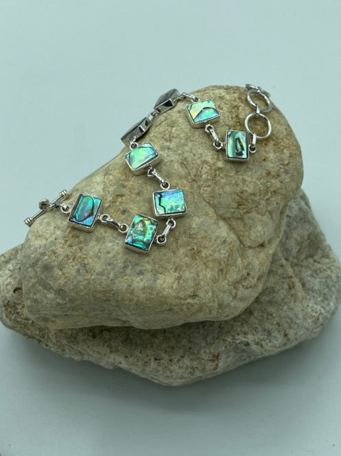 Abalone sterling silver toggle bracelet. The abalone shimmers just beautifully. The abalone is cut in the shape of rectangles.