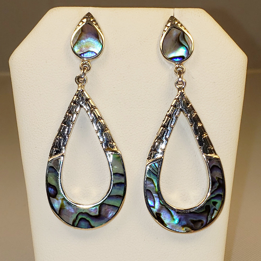 Sterling Silver Abalone earrings. They have a tear drop shape and are the star of the show. Bold earrings.