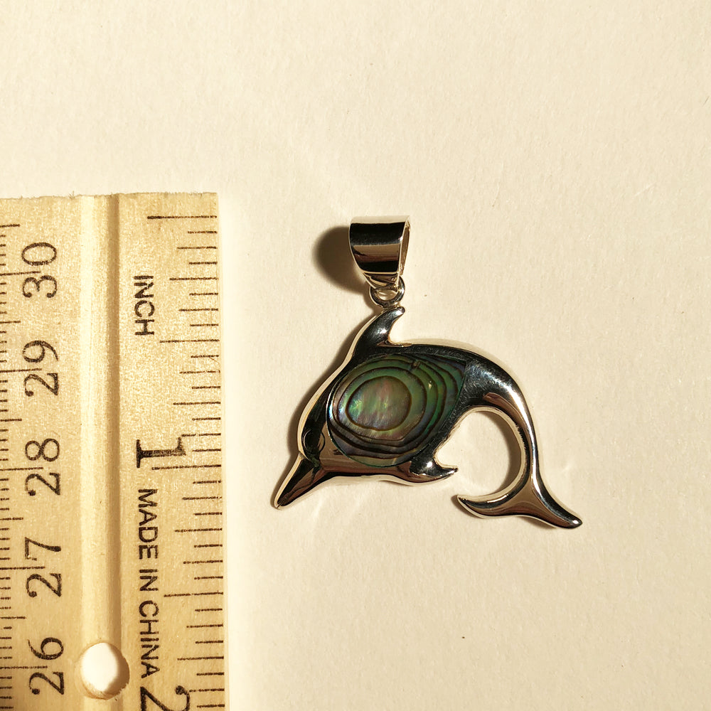 Abalone Sterling Silver Dolphin Pendant. Shiny sterling silver dolphin pendant with abalone shell in the center
