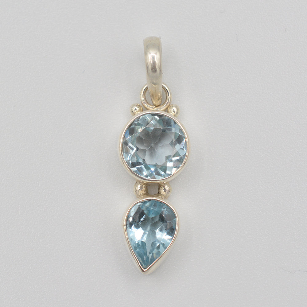 Semi-precious Blue Topaz Sterling Silver 2 stone Pendant. Top stone is round, bottom stone is tear drop.. 1" long