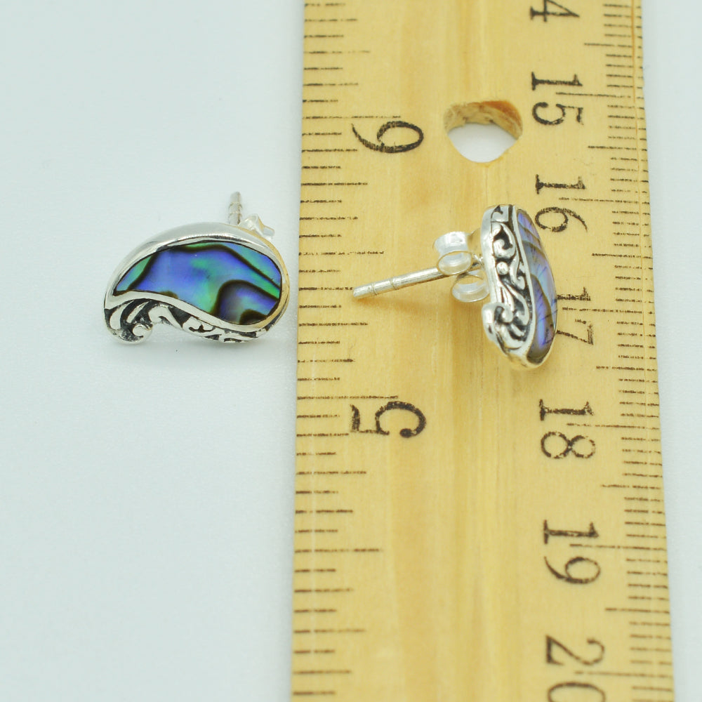 Abalone and Sterling Silver Stud Earrings. Pierced stud earrings with abalone and sterling silver scroll work. Less than a half in ch in size.