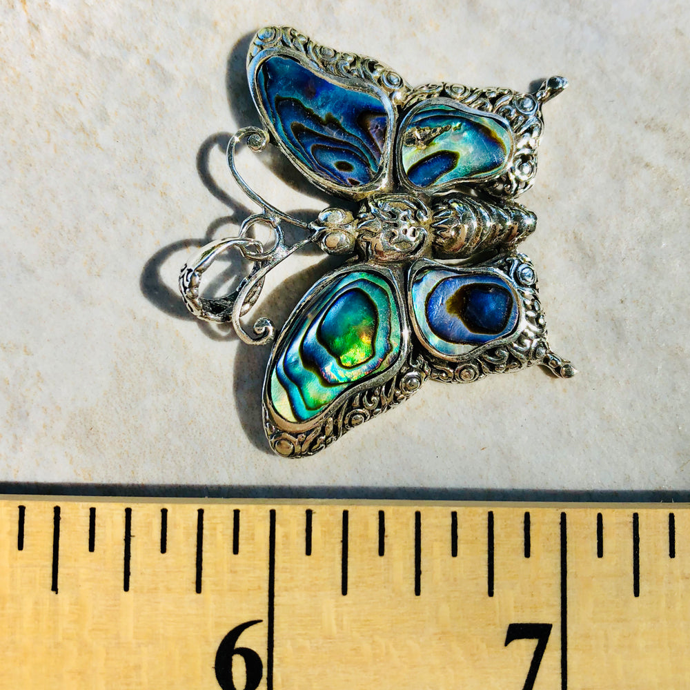 Abalone and Sterling Silver Butterfly Pendant. About an inch and a quarter. Lovely abalone.. Lovely silver scroll work. Made in Bali. 