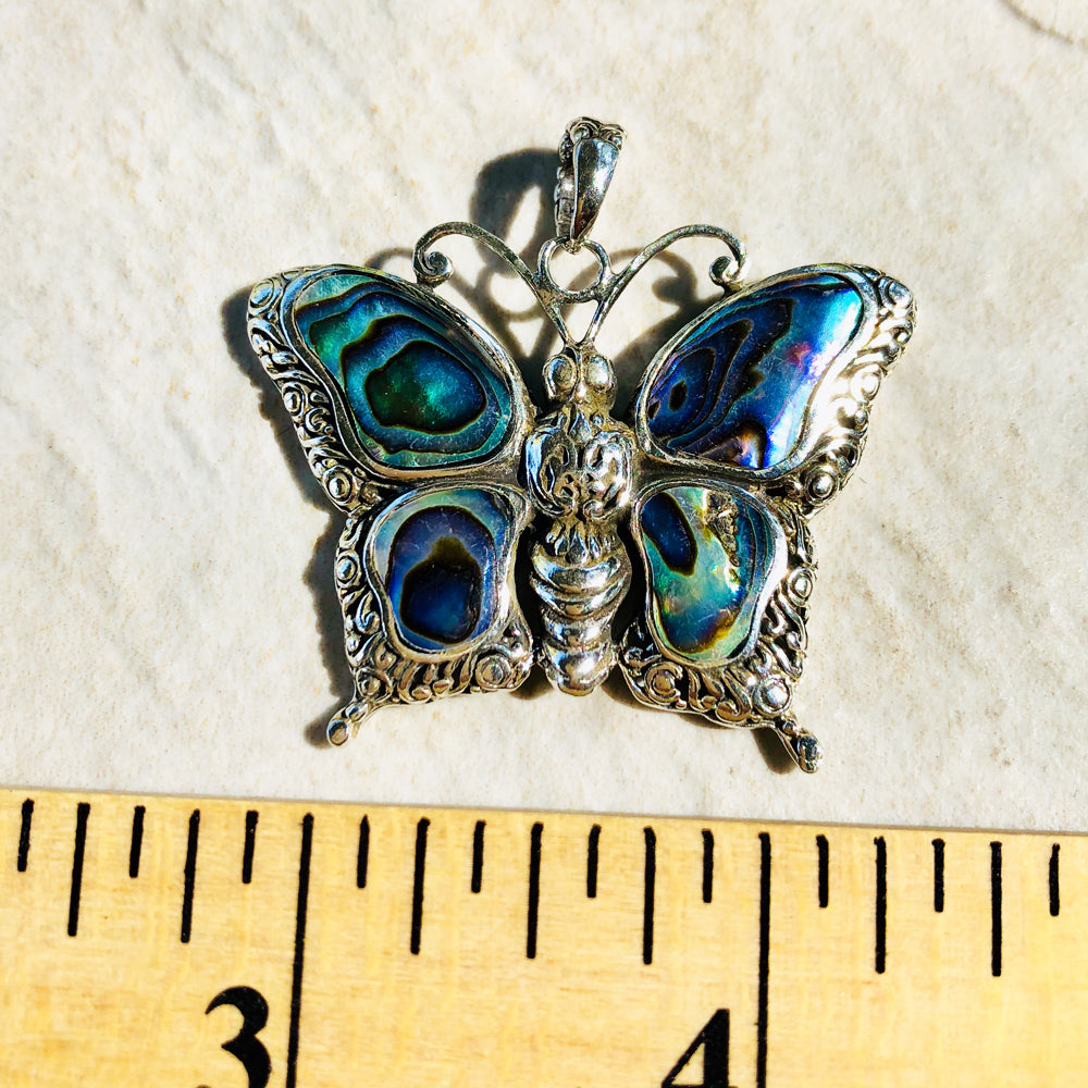 Abalone and Sterling Silver Butterfly Pendant. About an inch and a quarter. Lovely abalone.. Lovely silver scroll work. Made in Bali.