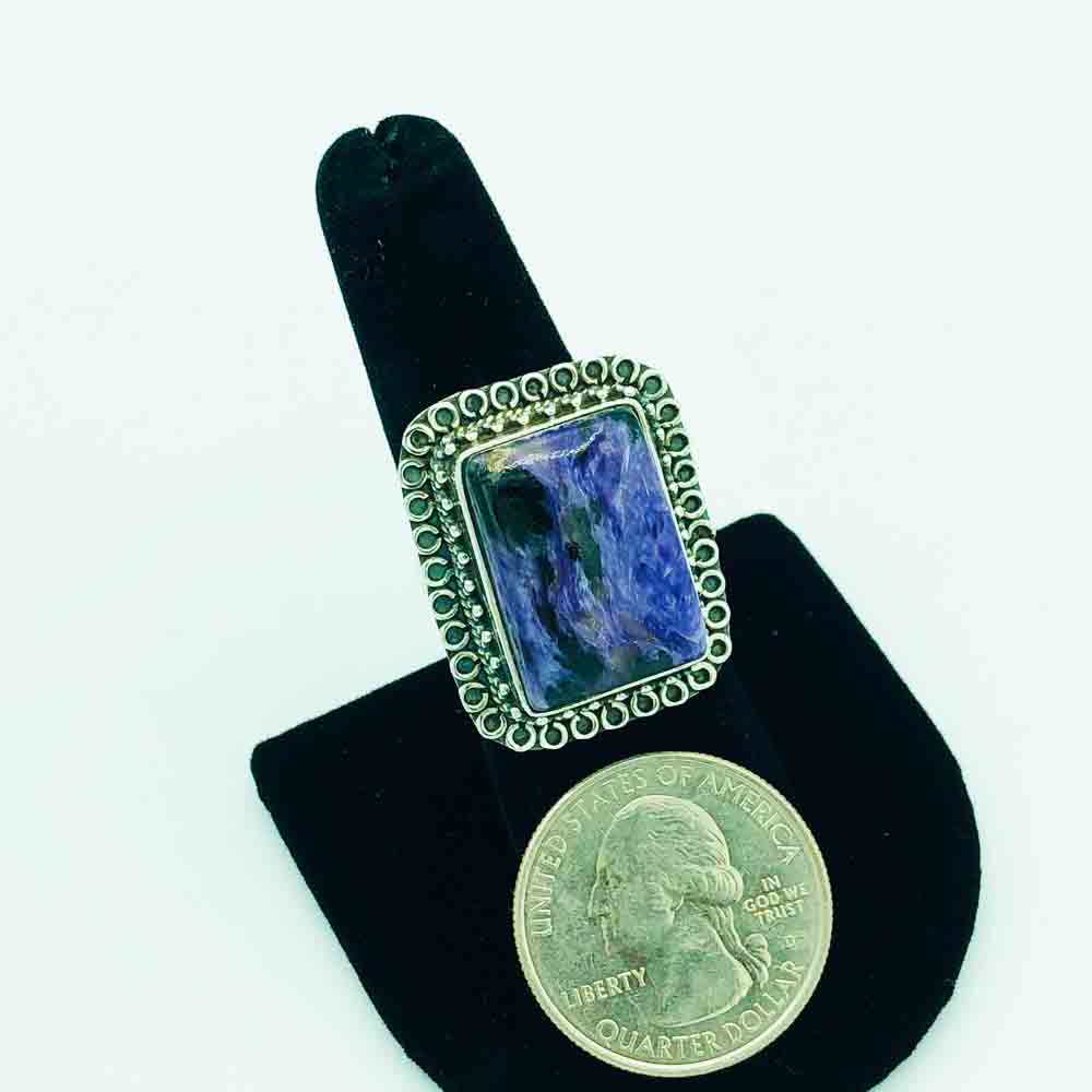 Charoite and Sterling Silver Ring-size 8. Shown with a quarter to judge the size. The face of the ring is about the size of a quarter although the ring is a rectangle shape.