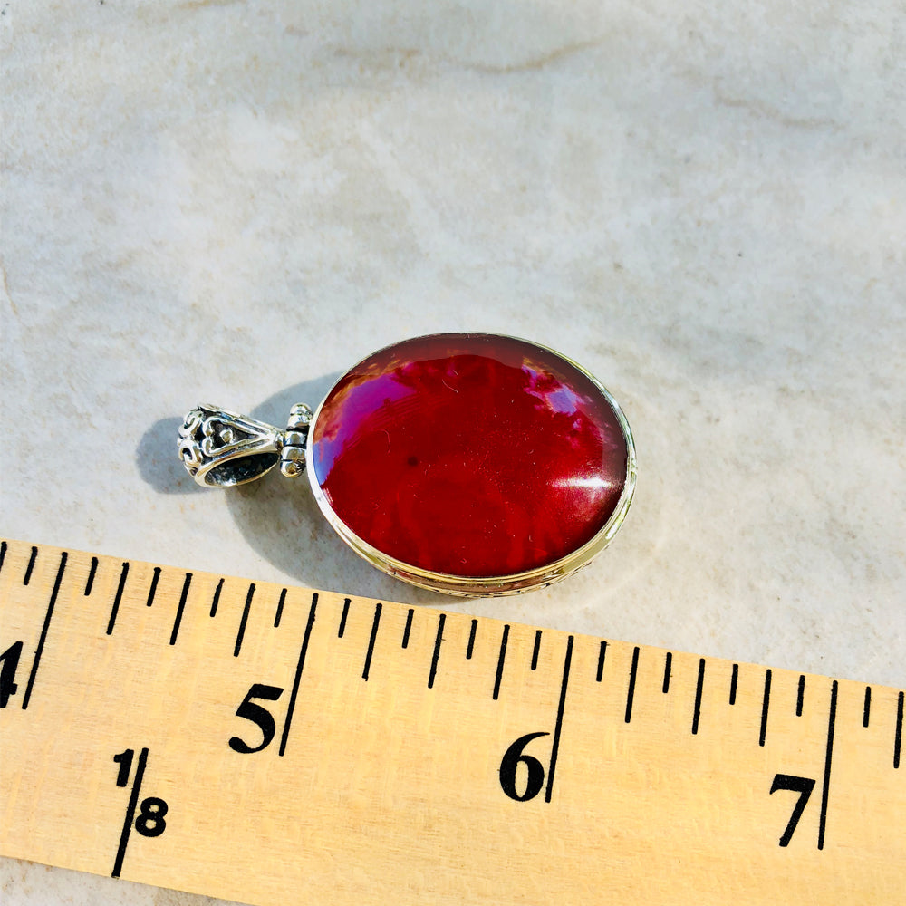 Abalone or Red Coral double sided Sterling Silver Pendant. Abalone on one side, red coral on the other. Oval shape. one and a half inches lon